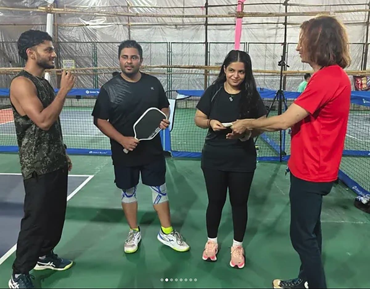 The Mixed Doubles winners of the last Mumbai Pickleball Cup holding their trophies on court