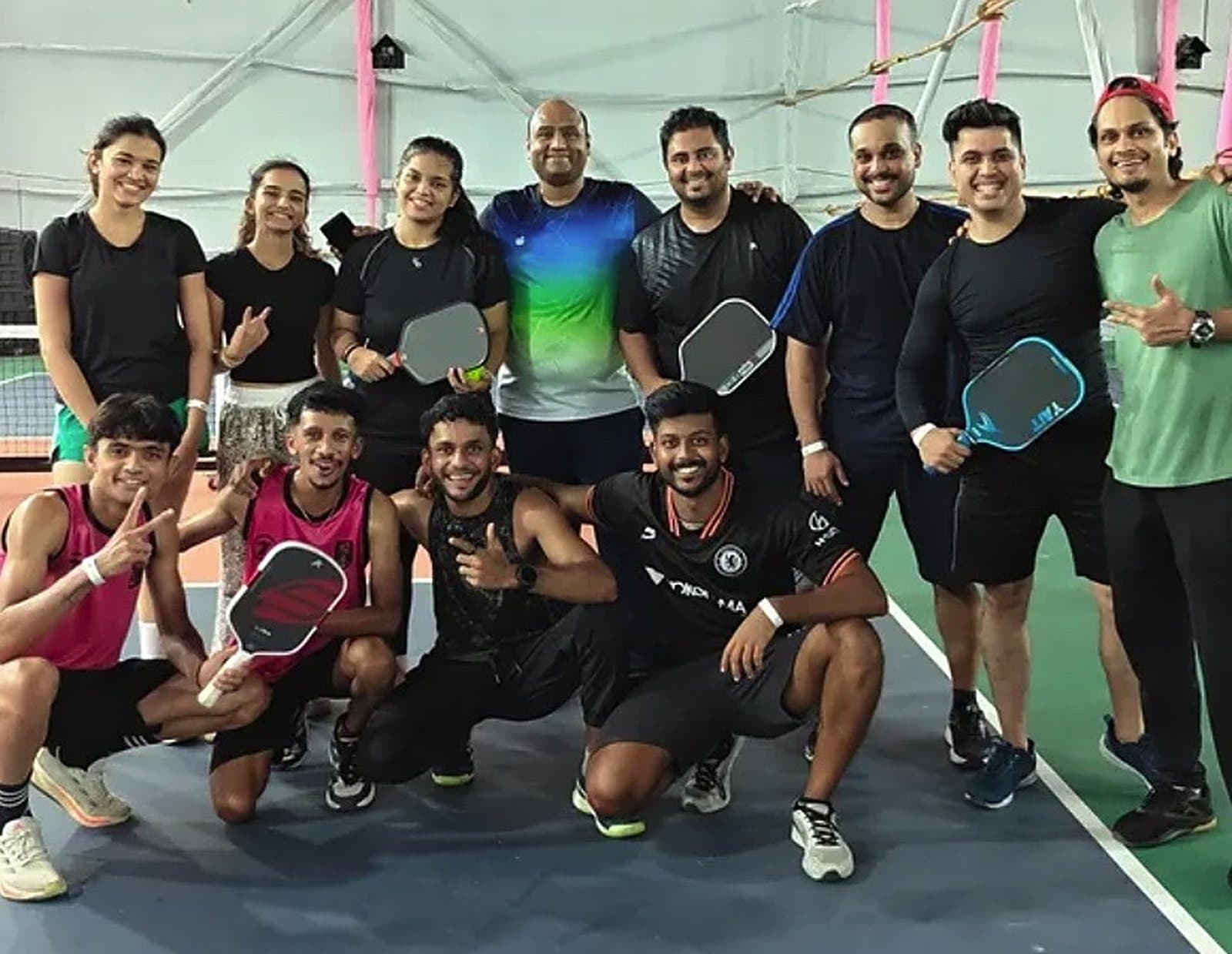 Players from the last Mumbai Pickleball Cup gathered on court with their paddles after a round of matches