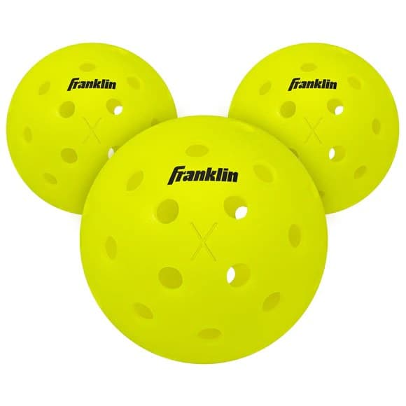 Three Franklin X-40 outdoor pickleballs showing the 40 drilled holes